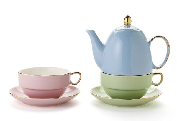 Tea set laid out neatly with cups and a teapot